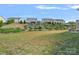 Large backyard with a stone patio area and tiered landscaping leading up to a retaining wall and fence at 7332 Newsome Sw Ct, Concord, NC 28025