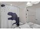 bathroom with large mirror, sink, and tub with dinosaur shower curtain at 7332 Newsome Sw Ct, Concord, NC 28025