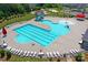 Aerial view showcasing a vibrant community pool with a splash area, lap lanes, and ample lounge seating at 7332 Newsome Sw Ct, Concord, NC 28025