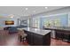 Open-concept kitchen featuring a granite island, stainless steel appliances, and hardwood floors at 7332 Newsome Sw Ct, Concord, NC 28025