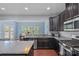 Kitchen with granite countertops, stainless steel appliances, and an adjacent dining area with backyard views at 7332 Newsome Sw Ct, Concord, NC 28025