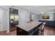Bright kitchen with stainless steel refrigerator, kitchen island, and a view to the living room at 7332 Newsome Sw Ct, Concord, NC 28025
