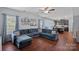 Open-concept living room with comfortable sectional, stylish decor, and seamless flow to the kitchen at 7332 Newsome Sw Ct, Concord, NC 28025
