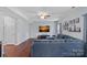Spacious living room with a large sectional sofa, a ceiling fan, and contemporary decor at 7332 Newsome Sw Ct, Concord, NC 28025