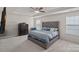 Spacious main bedroom featuring a tray ceiling, ceiling fan, and plush carpeting at 7332 Newsome Sw Ct, Concord, NC 28025