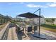 Spacious outdoor patio with ample seating and shade umbrella, ideal for entertaining guests with neighborhood views at 7332 Newsome Sw Ct, Concord, NC 28025