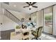 A home office that includes a staircase, a desk, record albums as decor, and a ceiling fan at 739 Hoke Ln, Davidson, NC 28036