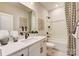 Well lit bathroom with white countertops, modern hardware, and shower-tub combo at 743 Hoke Ln, Davidson, NC 28036