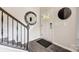 Entryway with staircase and wood-look flooring, complemented by stylish decor, including a decorative mirror at 743 Hoke Ln, Davidson, NC 28036