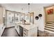 Modern kitchen with large island, stainless steel appliances, and wood flooring at 743 Hoke Ln, Davidson, NC 28036