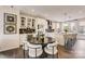 Open kitchen with island, white cabinets, stainless appliances, and a dining area at 743 Hoke Ln, Davidson, NC 28036