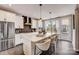 Modern kitchen features a large island with seating, white cabinets, and stainless appliances at 743 Hoke Ln, Davidson, NC 28036