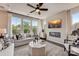 Bright living room with large windows, fireplace, modern ceiling fan, and stylish contemporary furniture and decor at 743 Hoke Ln, Davidson, NC 28036