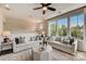 Bright living room features neutral decor, large windows, and modern ceiling fan at 743 Hoke Ln, Davidson, NC 28036