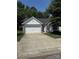 Charming single-Gathering home featuring a stone facade, a two-car garage and a well-manicured front lawn at 8708 Goldfields Dr, Charlotte, NC 28227