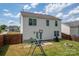 Back exterior of home with fenced yard, swing set, and patio at 937 Anchor Ne Way, Kannapolis, NC 28083