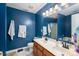 Bathroom with double vanity, blue walls, and white towels at 937 Anchor Ne Way, Kannapolis, NC 28083