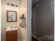 Bathroom with a wooden vanity, single sink, mirror, and three-light fixture at 937 Anchor Ne Way, Kannapolis, NC 28083