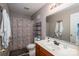 Bathroom with a single sink vanity, mirror, and shower with a floral curtain at 937 Anchor Ne Way, Kannapolis, NC 28083