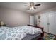 Bedroom with wood floors, a ceiling fan, and a patterned comforter at 937 Anchor Ne Way, Kannapolis, NC 28083