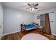 Cozy bedroom with hardwood floors, a soft rug, and a single bed with a stuffed panda at 937 Anchor Ne Way, Kannapolis, NC 28083