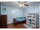 Bright bedroom with hardwood floors, ceiling fan, and shelving unit at 937 Anchor Ne Way, Kannapolis, NC 28083