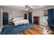 Bedroom featuring blue carpet, hardwood floors, a ceiling fan and ample natural light at 937 Anchor Ne Way, Kannapolis, NC 28083