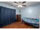 Cozy bedroom with hardwood floors, ceiling fan, and chest of drawers at 937 Anchor Ne Way, Kannapolis, NC 28083