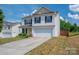 Exterior view of a two-story house with blue shutters and a two-car garage at 937 Anchor Ne Way, Kannapolis, NC 28083