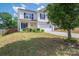 Two-story house with a bright yellow door, manicured landscaping, and a well-maintained lawn at 937 Anchor Ne Way, Kannapolis, NC 28083