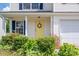 Close-up of house number above yellow door with decorative wreath and manicured shrubs at 937 Anchor Ne Way, Kannapolis, NC 28083