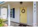 Close-up shot of yellow front door with wreath and house number at 937 Anchor Ne Way, Kannapolis, NC 28083