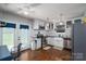 Spacious kitchen featuring white cabinets, stainless steel appliances, hardwood floors, and a cozy work desk at 937 Anchor Ne Way, Kannapolis, NC 28083