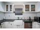 Bright kitchen with white cabinets, black countertops, subway tile backsplash, and stainless steel dishwasher at 937 Anchor Ne Way, Kannapolis, NC 28083