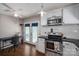 Well-lit kitchen with stainless steel appliances, white cabinetry, subway tile backsplash, and work desk at 937 Anchor Ne Way, Kannapolis, NC 28083