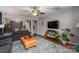 Spacious living room with seating, entertainment center, hardwood floors, and staircase at 937 Anchor Ne Way, Kannapolis, NC 28083