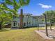 Home back exterior featuring a brick chimney, a pergola and well-maintained yard, ideal for outdoor living at 9430 Peckham Rye Rd, Mint Hill, NC 28227