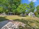 Large backyard featuring lush greenery, storage sheds, a pergola, and an inviting in-ground pool at 9430 Peckham Rye Rd, Mint Hill, NC 28227