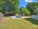Backyard features a private in-ground swimming pool surrounded by green grass at 9430 Peckham Rye Rd, Mint Hill, NC 28227
