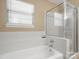 Bathroom featuring a soaking tub and a shower with glass doors at 9430 Peckham Rye Rd, Mint Hill, NC 28227