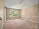 Bedroom with carpet, ceiling fan, and a large window at 9430 Peckham Rye Rd, Mint Hill, NC 28227
