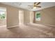 Open bedroom layout with carpet, ceiling fan, and windows at 9430 Peckham Rye Rd, Mint Hill, NC 28227