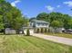 Lovely home boasting a spacious yard, mature trees, and a long driveway leading to a two-car garage at 9430 Peckham Rye Rd, Mint Hill, NC 28227
