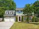 Charming two-story home with a well-manicured lawn, brick accents, and a two-car garage in a desirable neighborhood at 9430 Peckham Rye Rd, Mint Hill, NC 28227