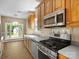View of the kitchen area showcasing wooden cabinetry and stainless steel appliances at 9430 Peckham Rye Rd, Mint Hill, NC 28227