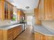 Bright kitchen featuring warm wood cabinets, stainless steel appliances, and tile flooring at 9430 Peckham Rye Rd, Mint Hill, NC 28227