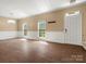 Bright living room featuring hardwood floors, wainscoting, elegant lighting, and a welcoming entrance at 9430 Peckham Rye Rd, Mint Hill, NC 28227