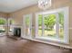 Living room with a fireplace and a bay window overlooking the backyard at 9430 Peckham Rye Rd, Mint Hill, NC 28227