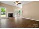 Comfortable living room features hardwood floors, a brick fireplace, and access to the backyard at 9430 Peckham Rye Rd, Mint Hill, NC 28227