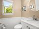 Charming powder room with a modern vanity, stylish mirror, and updated fixtures for added convenience at 9430 Peckham Rye Rd, Mint Hill, NC 28227